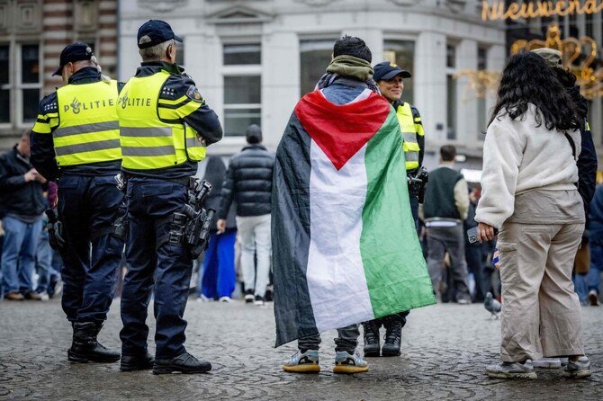 Netherlands' Police officers stand by as people gather during a small pro-Palestinian demonstration on Dam Square in Amsterdam, on November 9, 2024.