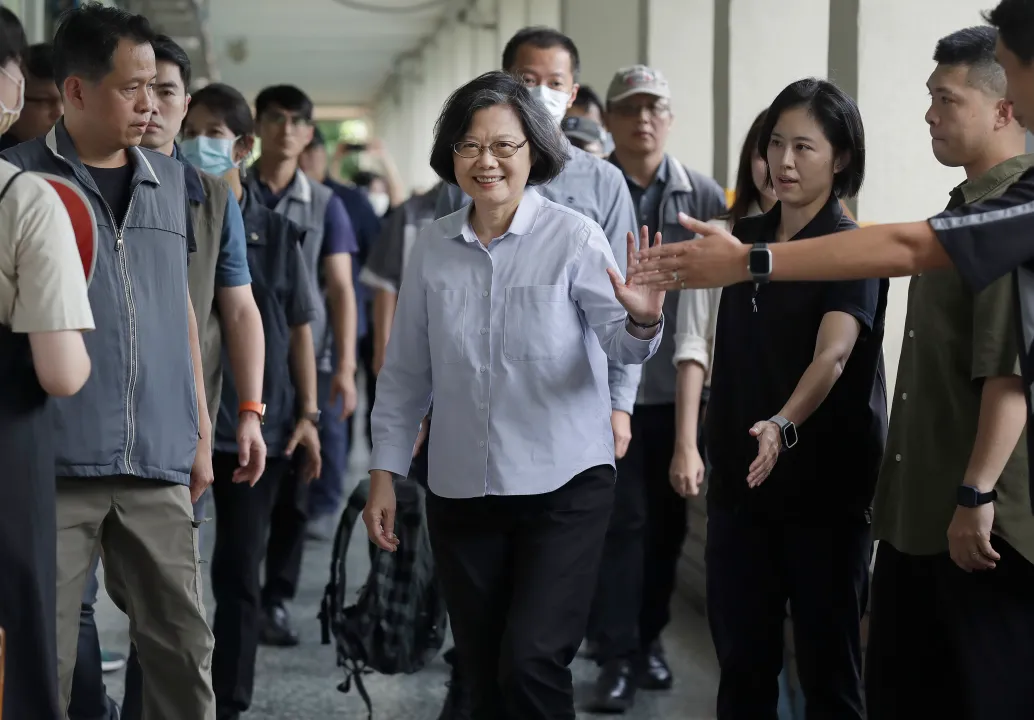 Former Taiwan President Tsai Ing-wen, center, waves to medias in Taipei, Taiwan, Saturday, July 26, 2025.