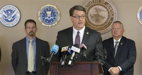 U.S. Attorney Robert J. Troester speaks at podium.