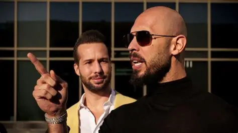 Andrew Tate gestures, next to his brother Tristan, outside the Bucharest Tribunal.