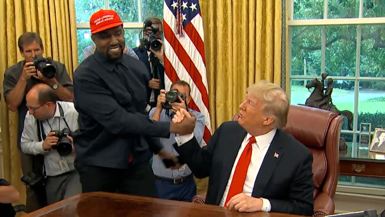 President Donald Trump greets rapper Kanye West during a meeting in the Oval office of the White House in Washington on Oct. 11, 2018.