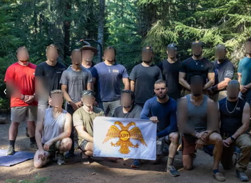 Ian Elliott (front row, third from right) poses for a picture alongside other workers for federal security contractor Knight Division Tactical.