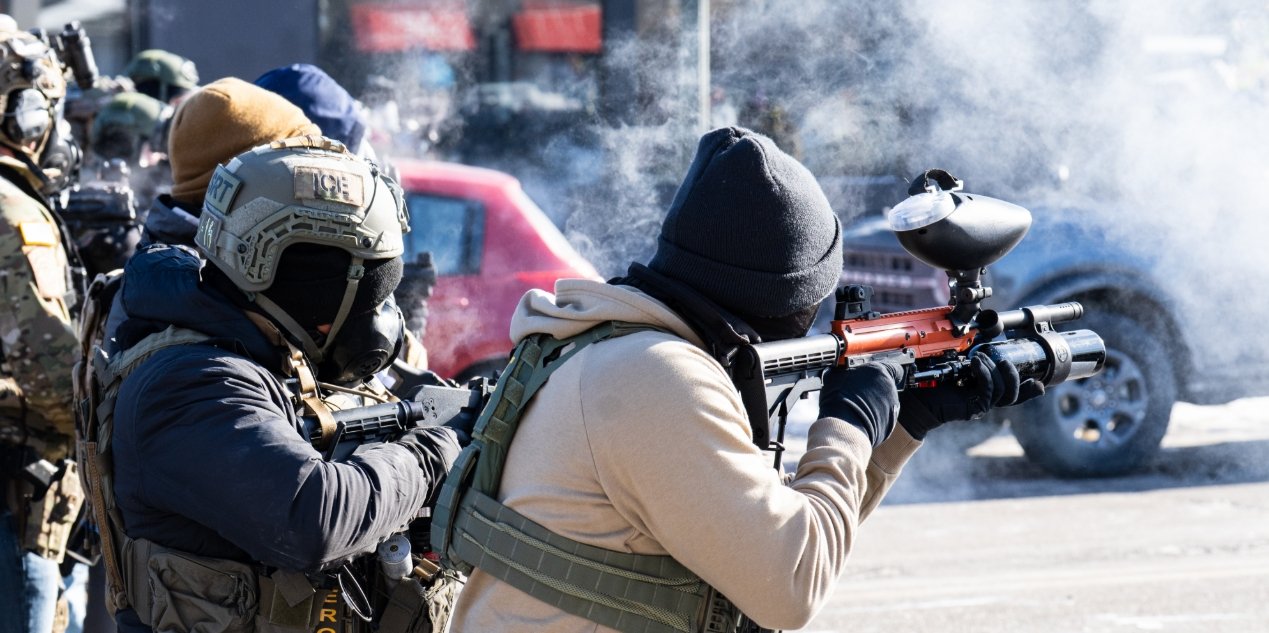 Law enforcement in Minneapolis defending against violent protestors with nonlethal equipment.