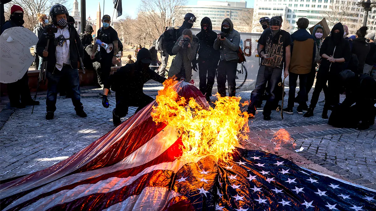 Antifa burns the US flag.