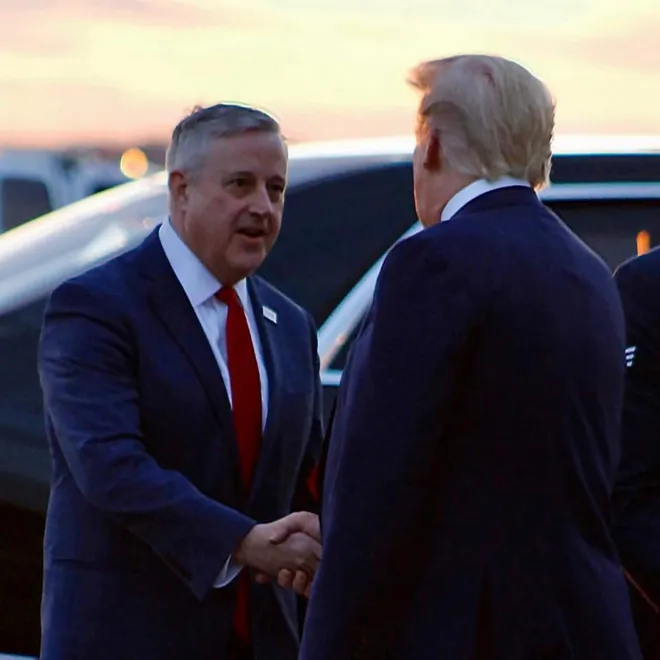 Michael Whatley (left) shakes hands with then-president Donald Trump (right).